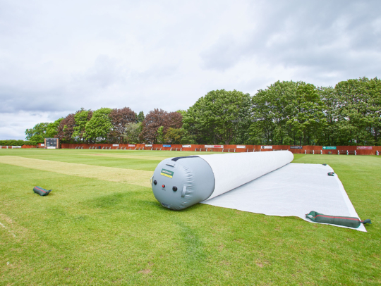 Matchsaver air roller pitch cover protecting a cricket pitch